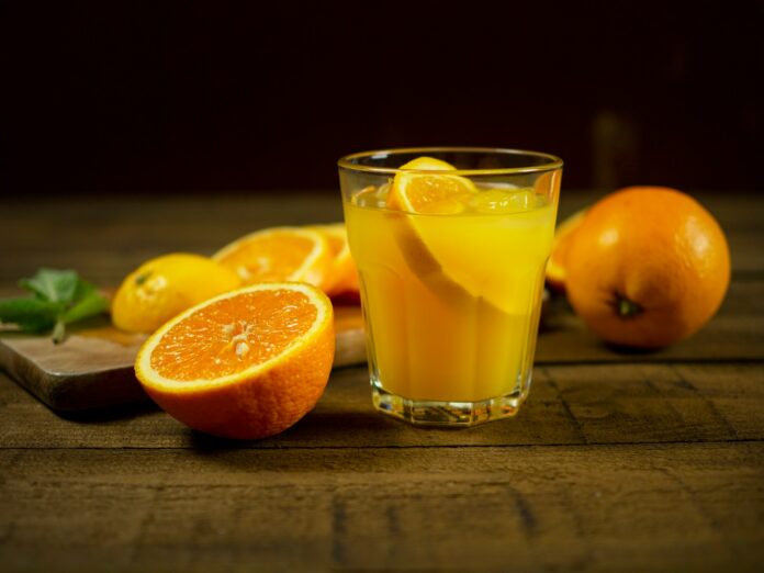 Photo by Mateusz Feliksik orange juice in clear drinking glass
