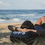 일상 속 스트레스, 건강하게 다스리는 실천법 ‘눈길’ woman lying on grass front of sea at daytime