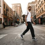 바쁜 일상 속 ‘걷기 습관’이 부른 건강 트렌드… 실천법과 생활 속 팁 man in white long sleeve shirt and black pants standing on road during daytime